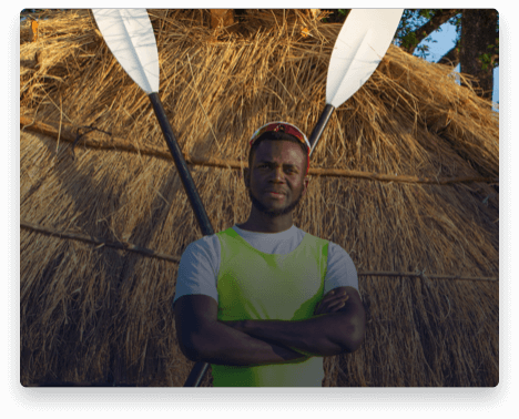 iFit Trainer Desmond Nanchengwa standing with his rowing oars in Zambia.