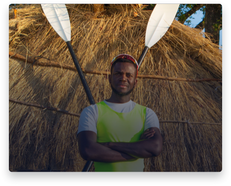 iFit Trainer Desmond Nanchengwa standing with his rowing oars in Zambia.