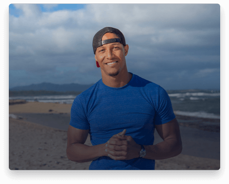 iFit Trainer Jonnie Gale standing on a beach in Hawaii.