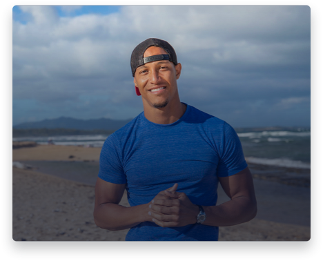 iFit Trainer Jonnie Gale standing on a beach in Hawaii.