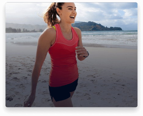 iFit Trainer Kirsty Godso walking on a beach in Hawaii.