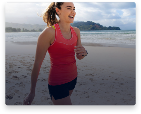 iFit Trainer Kirsty Godso walking on a beach in Hawaii.