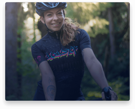 iFit Trainer Kym Perfetto standing with her bike in Oregon.