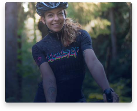 iFit Trainer Kym Perfetto standing with her bike in Oregon.