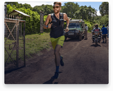 iFit Trainer Zac Marion running on a dirt road.