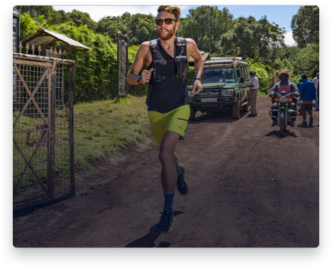 iFit Trainer Zac Marion running on a dirt road.