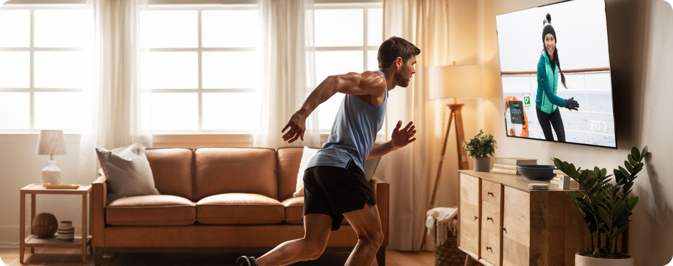 White man running in place in front of the iFIT TV app.
