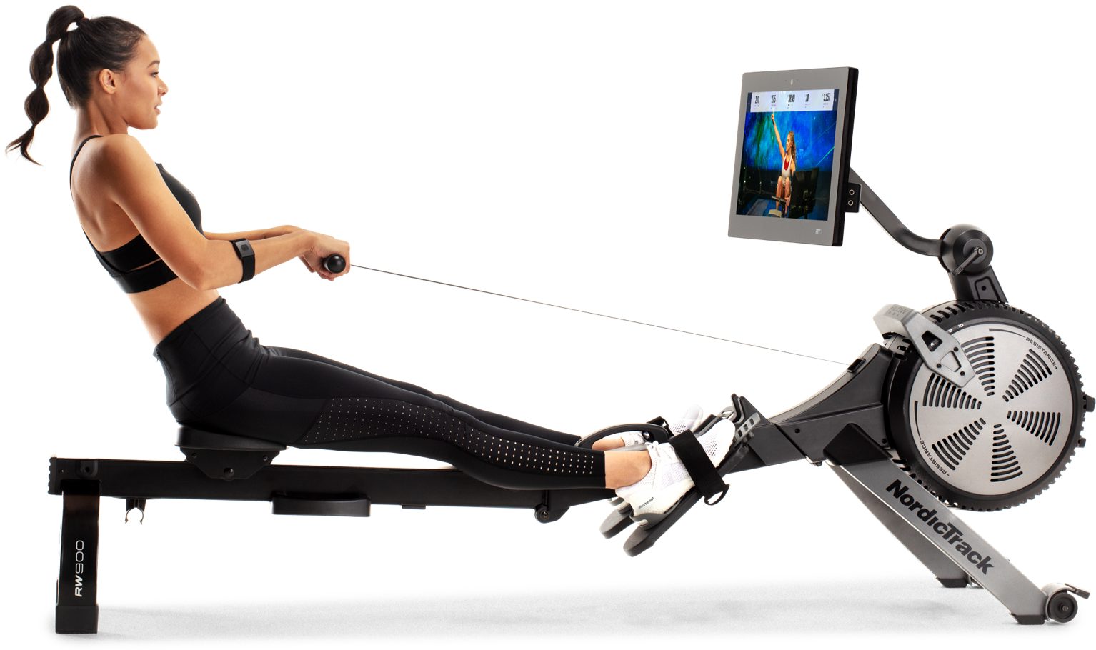 Woman rowing on a rower with the iFit app.
