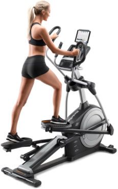 A woman exercising on an ellitpcal machine.