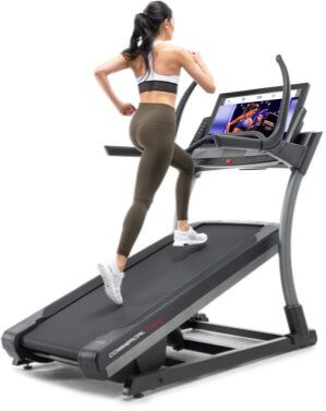 A woman running on an incline trainer.