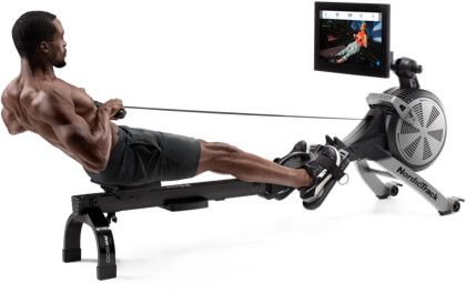 A man exercising on a rowing machine.
